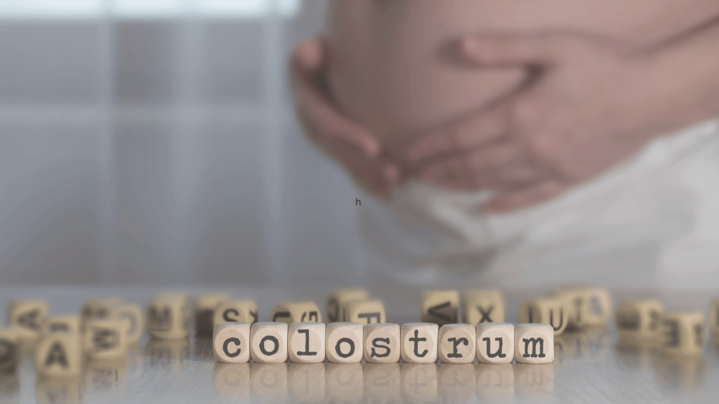 colostrum spelled out in front of a pregnant woman