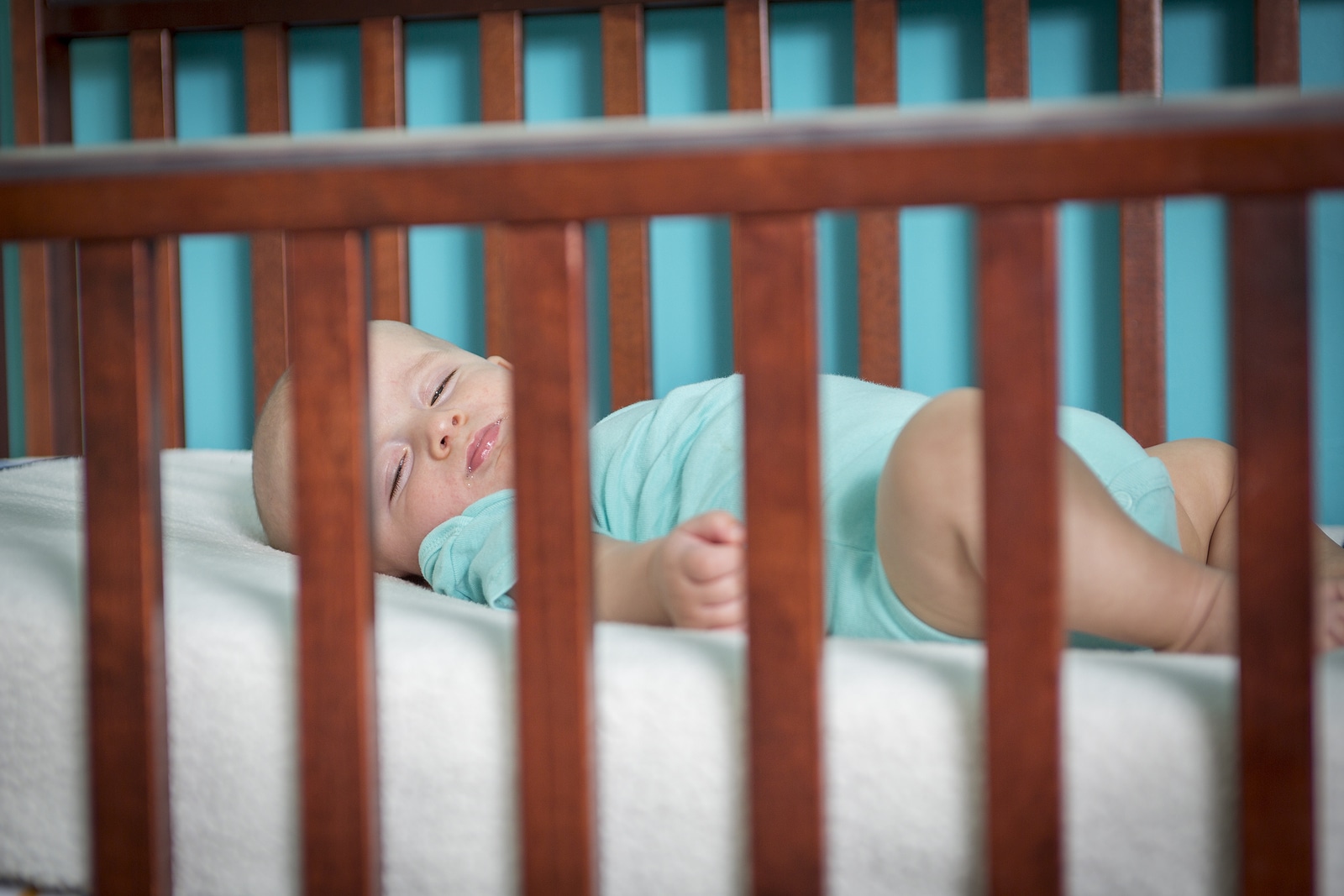 Adorable baby in his crib