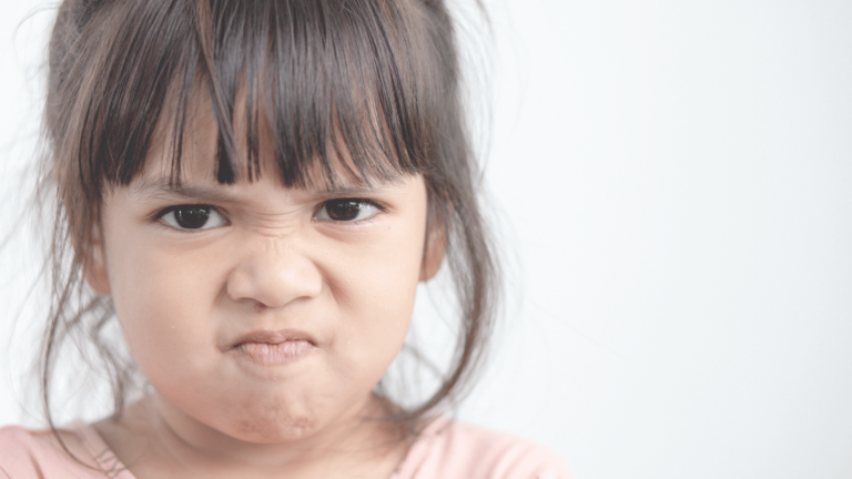 Upset toddler with frown